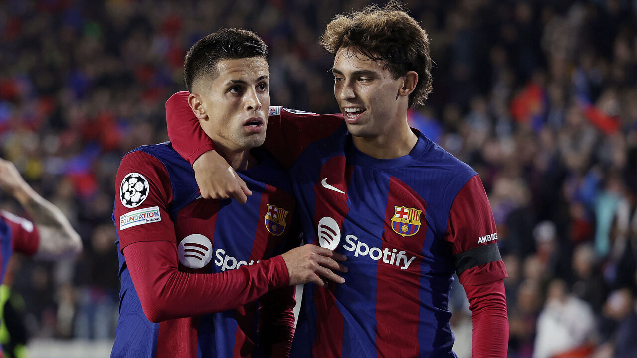 BARCELONA, SPAIN - NOVEMBER 28: Joao Cancelo of FC Barcelona celebrates 1-1 with Joao Felix of FC Barcelona during the UEFA Champions League match between FC Barcelona v FC Porto at the Lluis Companys Olympic Stadium on November 28, 2023 in Barcelona Spain