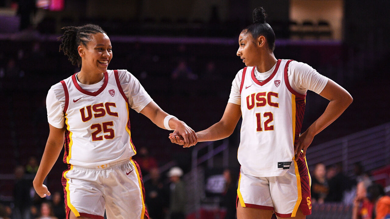 LOS ANGELES, CA - NOVEMBER 28: USC Trojans guard McKenzie Forbes (25) gives USC Trojans guard JuJu Watkins (12) a high five during the women's college basketball game between the Cal Poly Mustangs and the USC Trojans on November 28, 2023 at Galen Center in Los Angeles, CA.