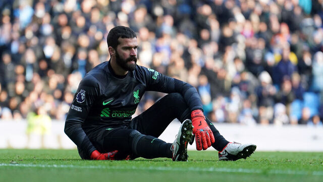 Liverpool goalkeeper Alisson Becker sits injured during the Premier League match at the Etihad Stadium, Manchester. Picture date: Saturday November 25, 2023.