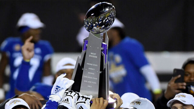 LAS VEGAS, NEVADA - DECEMBER 19: San Jose State Spartans players celebrate with the championship trophy after defeating the Boise State Broncos 34-20 to win the Mountain West Football Championship at Sam Boyd Stadium on December 19, 2020 in Las Vegas, Nevada.