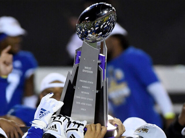 LAS VEGAS, NEVADA - DECEMBER 19: San Jose State Spartans players celebrate with the championship trophy after defeating the Boise State Broncos 34-20 to win the Mountain West Football Championship at Sam Boyd Stadium on December 19, 2020 in Las Vegas, Nevada.