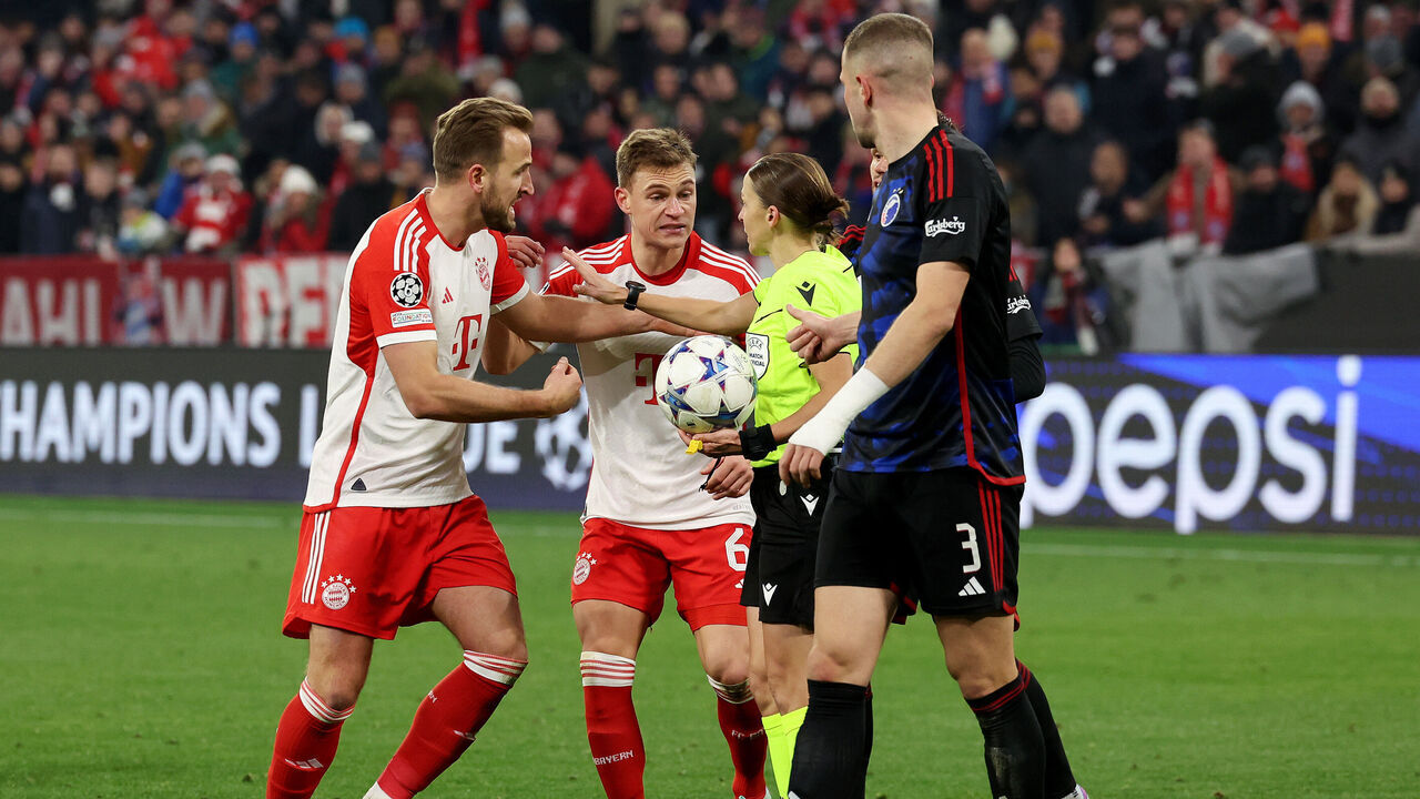 MUNICH, GERMANY - NOVEMBER 29: Harry Kane and Joshua Kimmich of Bayern Munich react towards Referee Stephanie Frappart following a VAR review over a penalty kick which was not awarded to Bayern Munich during the UEFA Champions League match between FC Bayern München and F.C. Copenhagen at Allianz Arena on November 29, 2023 in Munich, Germany.