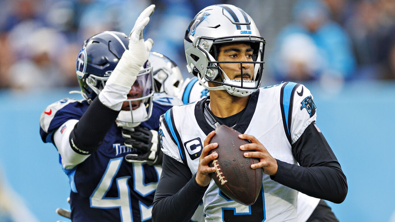NASHVILLE, TENNESSEE - NOVEMBER 26: Bryce Young #9 of the Carolina Panthers drops back to pass under pressure from Arden Key #49 of the Tennessee Titans at Nissan Stadium on November 26, 2023 in Nashville, Tennessee. The Titans defeated the Panthers 17-10.