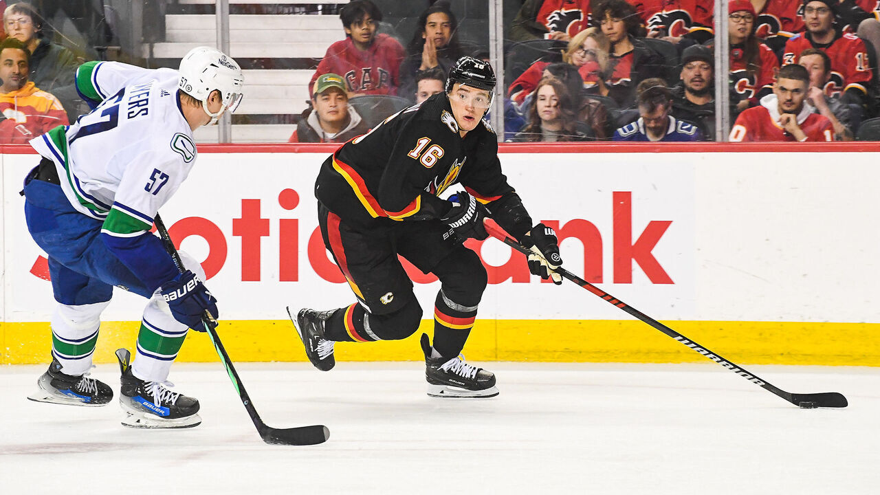 CALGARY, CANADA - NOVEMBER 16: Nikita Zadorov #16 of the Calgary Flames skates with the puck against Tyler Myers #57 of the Vancouver Canucks during the third period of an NHL game at Scotiabank Saddledome on November 16, 2023 in Calgary, Alberta, Canada. The Flames defeated the Canucks 5-2.