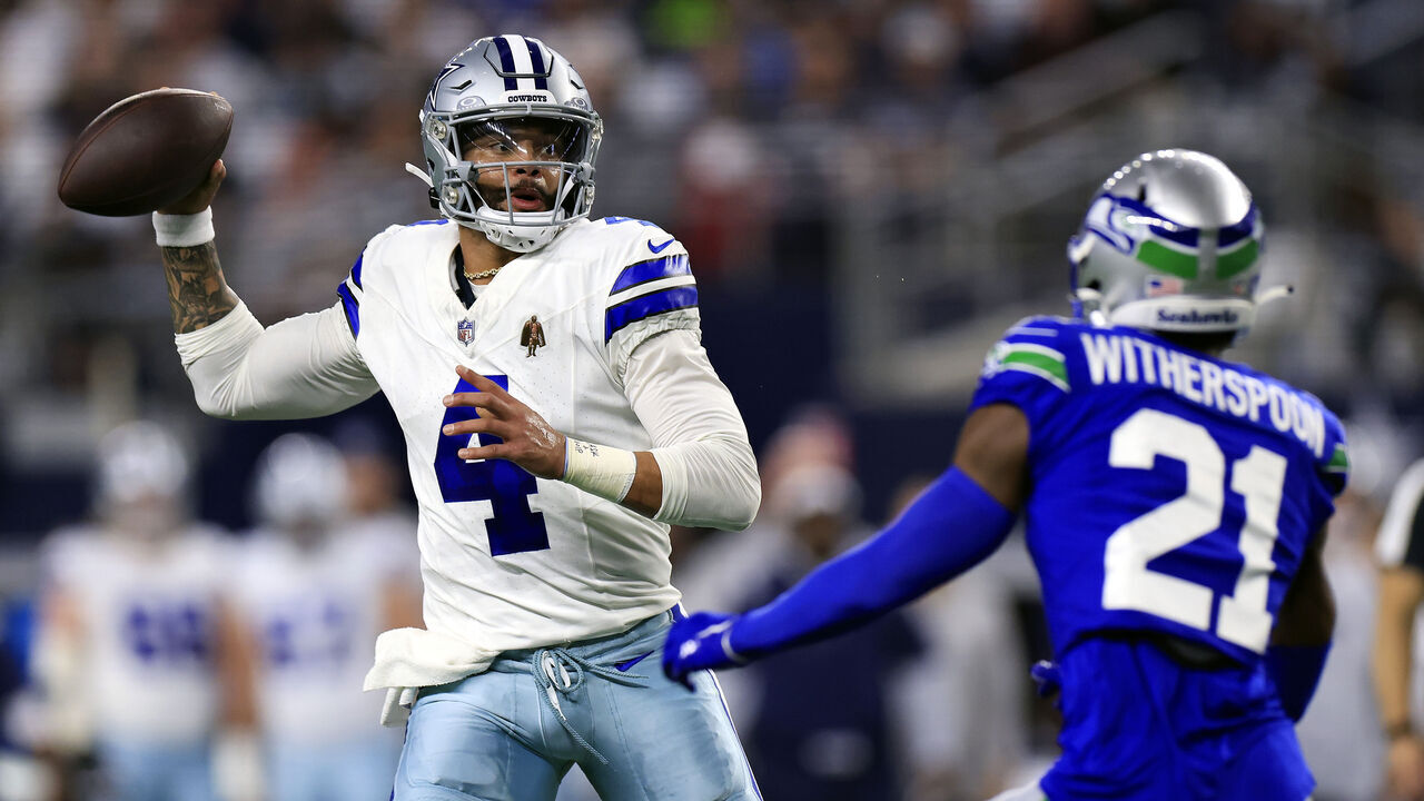 ARLINGTON, TEXAS - NOVEMBER 30: Quarterback Dak Prescott #4 of the Dallas Cowboys looks to pass as cornerback Devon Witherspoon #21 of the Seattle Seahawks defends during the 1st quarter of the game at AT&T Stadium on November 30, 2023 in Arlington, Texas.