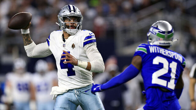 ARLINGTON, TEXAS - NOVEMBER 30: Quarterback Dak Prescott #4 of the Dallas Cowboys looks to pass as cornerback Devon Witherspoon #21 of the Seattle Seahawks defends during the 1st quarter of the game at AT&T Stadium on November 30, 2023 in Arlington, Texas.