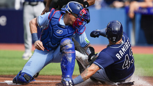 TORONTO, ON - OCTOBER 1: Harold Ramirez #43 of the Tampa Bay Rays scores against Tyler Heineman #55 of the Toronto Blue Jays during the first inning in their MLB game at the Rogers Centre on October 1, 2023 in Toronto, Ontario, Canada.