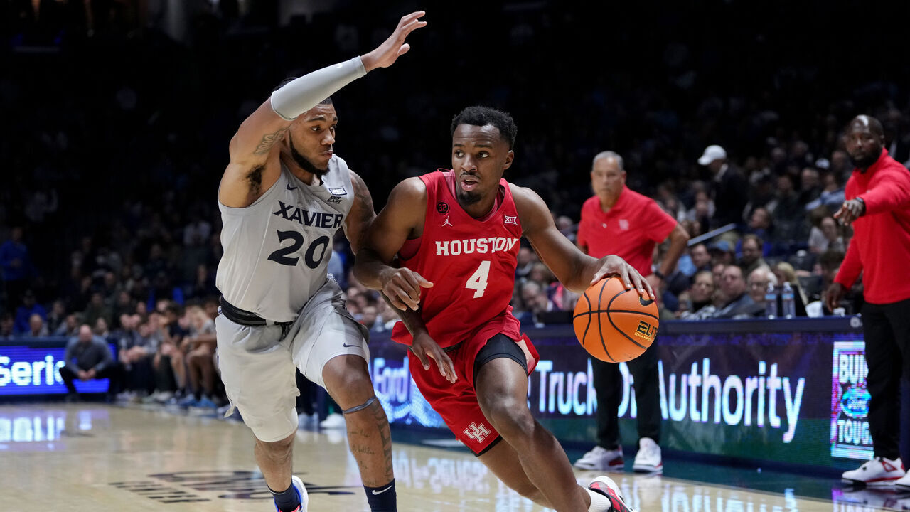 CINCINNATI, OHIO - DECEMBER 01: L.J. Cryer #4 of the Houston Cougars drives to the basket while Dayvion McKnight #20 of the Xavier Musketeers defends in the second half at the Cintas Center on December 01, 2023 in Cincinnati, Ohio.