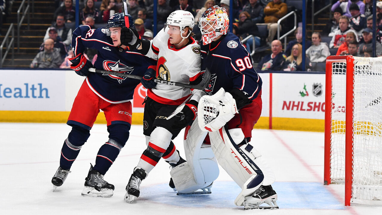 COLUMBUS, OHIO - December 1: Jake Bean #22 of the Columbus Blue Jackets, Parker Kelly #27 of the Ottawa Senators and goaltender Elvis Merzlikins #90 of the Columbus Blue Jackets battle for position during the second period of a game at Nationwide Arena on December 1, 2023 in Columbus, Ohio.