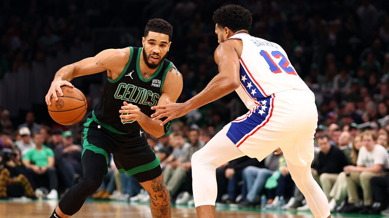 BOSTON, MASSACHUSETTS - DECEMBER 01: Jayson Tatum #0 of the Boston Celtics drives to the basket against Tobias Harris #12 of the Philadelphia 76ers during the first quarter at TD Garden on December 01, 2023 in Boston, Massachusetts.