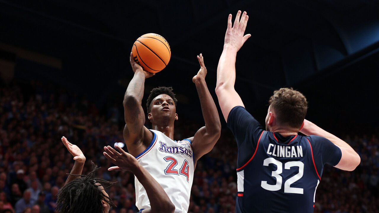 LAWRENCE, KANSAS - DECEMBER 01: KJ Adams Jr. #24 of the Kansas Jayhawks shoots over Donovan Clingan #32 of the Connecticut Huskies during the 1st half of the game at Allen Fieldhouse on December 01, 2023 in Lawrence, Kansas.