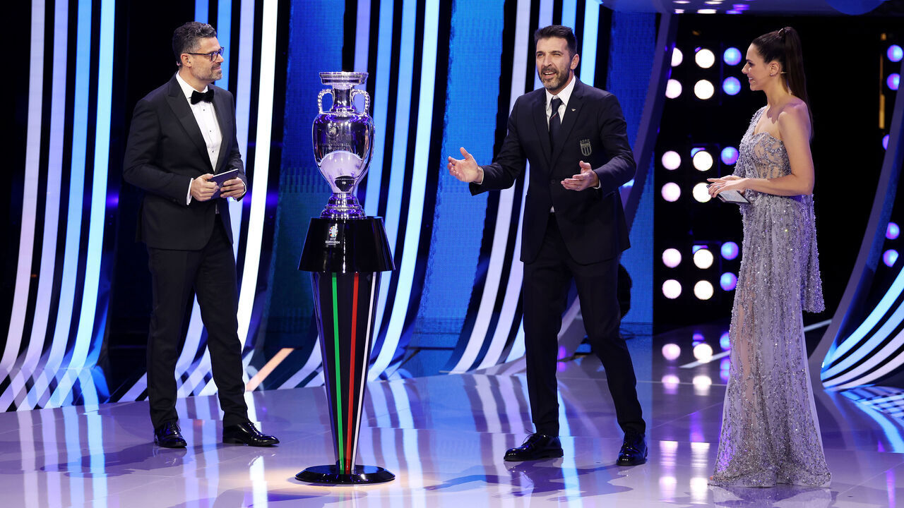 HAMBURG, GERMANY - DECEMBER 02: Presenters Esther Sedlaczek and Pedro Pinto and special guest Gianluigi Buffon​ speak during the UEFA EURO 2024 Final Tournament Draw at Elbphilharmonie on December 02, 2023 in Hamburg, Germany.