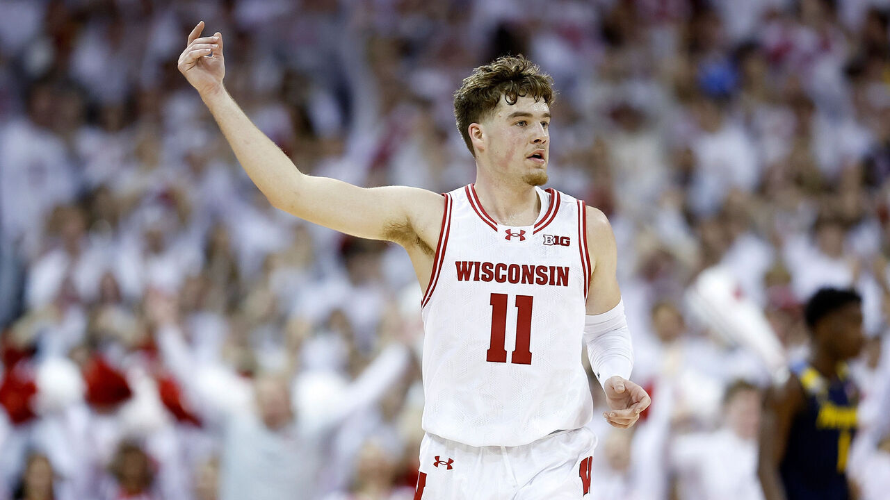 MADISON, WISCONSIN - DECEMBER 02: Max Klesmit #11 of the Wisconsin Badgers reacts after hitting his fifth three point shot in the first half of the game against the Marquette Golden Eagles at Kohl Center on December 02, 2023 in Madison, Wisconsin.