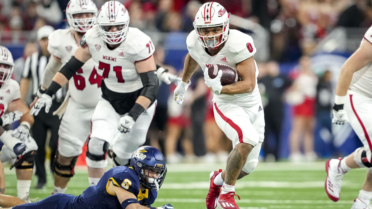 DETROIT, MICHIGAN - DECEMBER 02: Rashad Amos #0 of the Miami (Oh) Redhawks runs the ball against Nate Bauer #6 of the Toledo Rockets during the first quarter of the MAC Championship at Ford Field on December 02, 2023 in Detroit, Michigan.