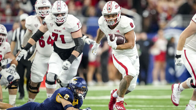 DETROIT, MICHIGAN - DECEMBER 02: Rashad Amos #0 of the Miami (Oh) Redhawks runs the ball against Nate Bauer #6 of the Toledo Rockets during the first quarter of the MAC Championship at Ford Field on December 02, 2023 in Detroit, Michigan.