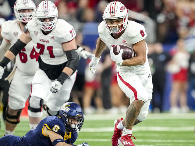DETROIT, MICHIGAN - DECEMBER 02: Rashad Amos #0 of the Miami (Oh) Redhawks runs the ball against Nate Bauer #6 of the Toledo Rockets during the first quarter of the MAC Championship at Ford Field on December 02, 2023 in Detroit, Michigan.