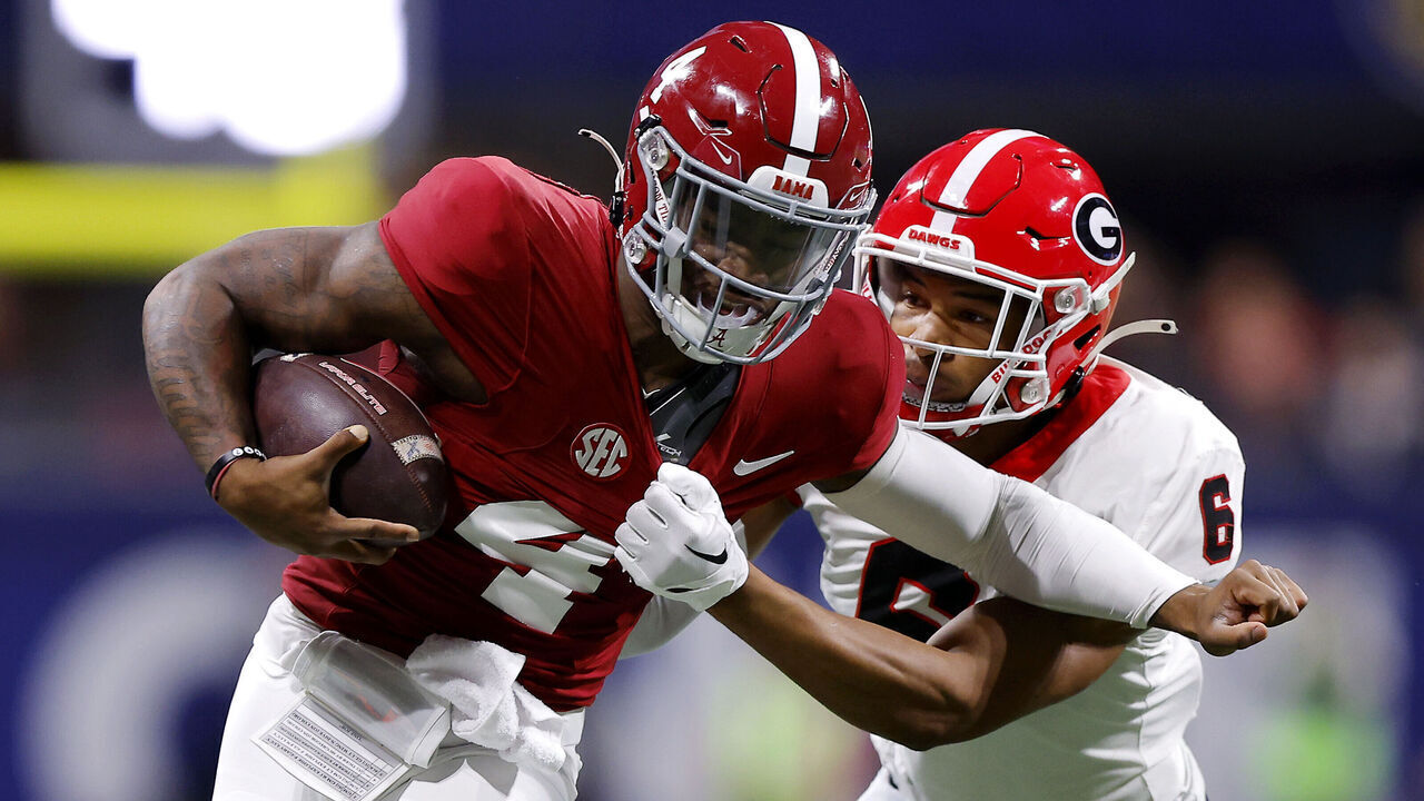 ATLANTA, GEORGIA - DECEMBER 02: Daylen Everette #6 of the Georgia Bulldogs tackles Jalen Milroe #4 of the Alabama Crimson Tide during the first quarter in the SEC Championship at Mercedes-Benz Stadium on December 02, 2023 in Atlanta, Georgia.