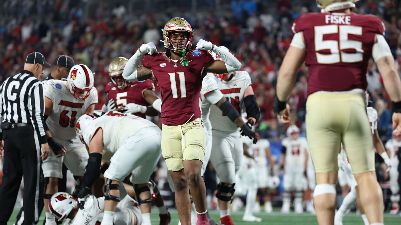 CHARLOTTE, NORTH CAROLINA - DECEMBER 2: Patrick Payton #11 of the Florida State Seminoles reacts after Braden Fiske #55 of the Florida State Seminoles sacks Jack Plummer #13 of the Louisville Cardinals during the second half during the ACC Championship at Bank of America Stadium on December 2, 2023 in Charlotte, North Carolina.
