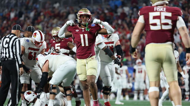 CHARLOTTE, NORTH CAROLINA - DECEMBER 2: Patrick Payton #11 of the Florida State Seminoles reacts after Braden Fiske #55 of the Florida State Seminoles sacks Jack Plummer #13 of the Louisville Cardinals during the second half during the ACC Championship at Bank of America Stadium on December 2, 2023 in Charlotte, North Carolina.