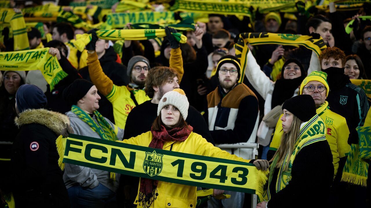 Nantes' supporters cheer their team during the French L1 football match between FC Nantes and OGC Nice at La Beaujoire stadium in Nantes, western France on December 2, 2023.