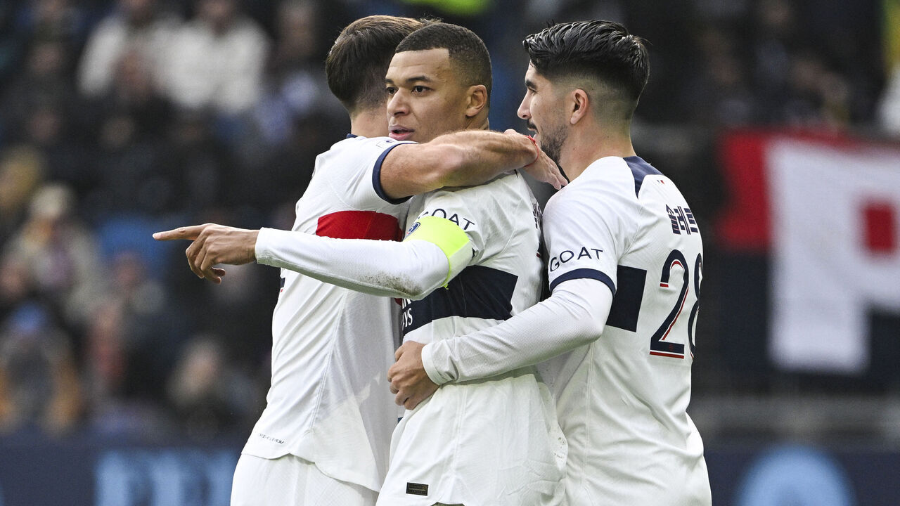 Paris Saint-Germain's French forward #07 Kylian Mbappe (C) celebrates with Paris Saint-Germain's Spanish midfielder #28 Carlos Soler (R) after scoring his team's first goal during the French L1 football match between Le Havre AC and Paris Saint-Germain (PSG) at The Stade Oceane in Le Havre, north-western France, on December 3, 2023.