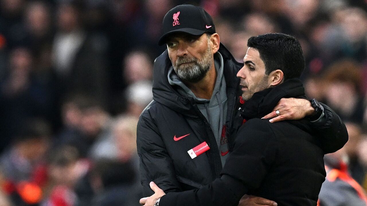 Liverpool's German manager Jurgen Klopp (L) embraces Arsenal's Spanish manager Mikel Arteta after the English Premier League football match between Liverpool and Arsenal at Anfield in Liverpool, north west England on April 9, 2023. - The match ended 2-2.