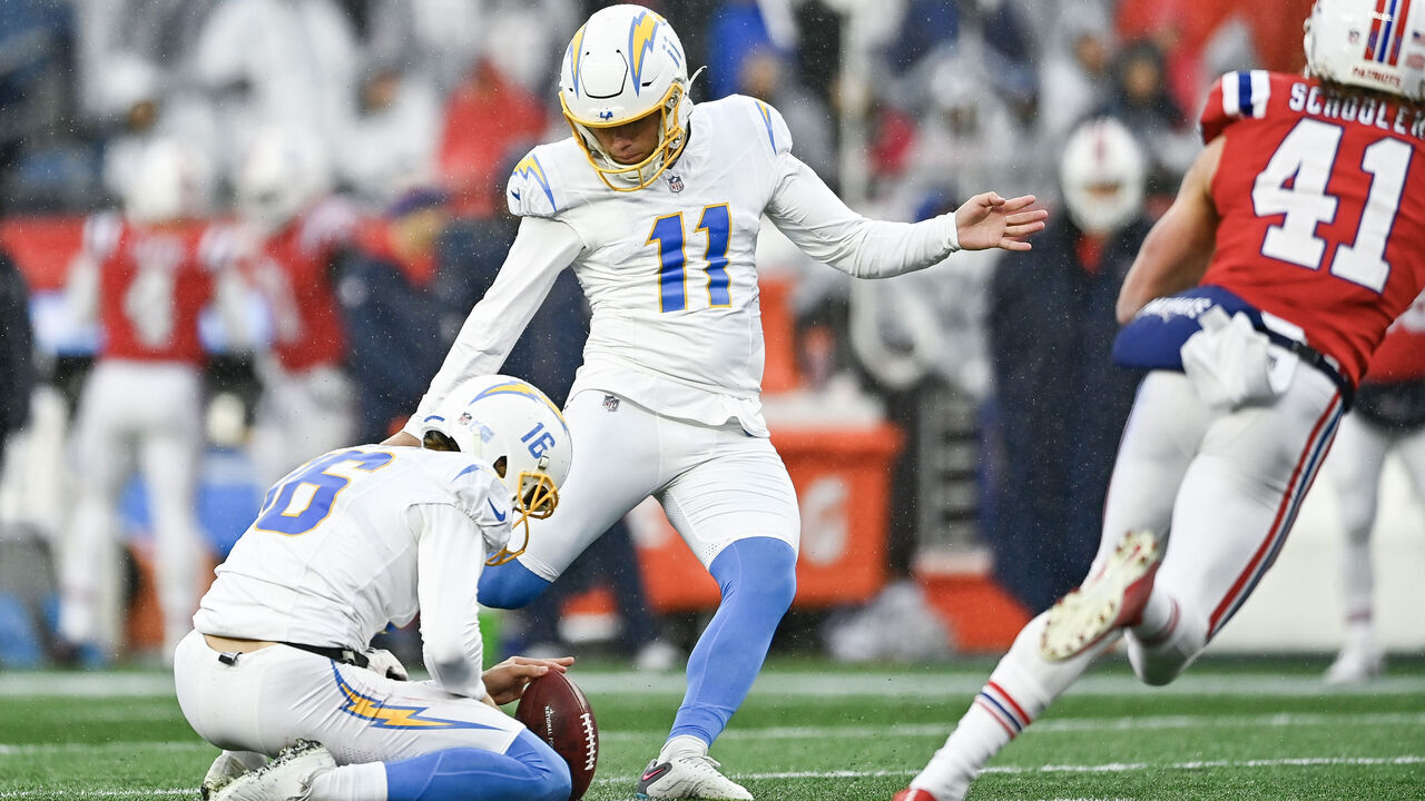 FOXBOROUGH, MASSACHUSETTS - DECEMBER 03: Cameron Dicker #11 of the Los Angeles Chargers kicks a field goal as JK Scott #16 holds in the second quarter against the New England Patriots at Gillette Stadium on December 03, 2023 in Foxborough, Massachusetts.