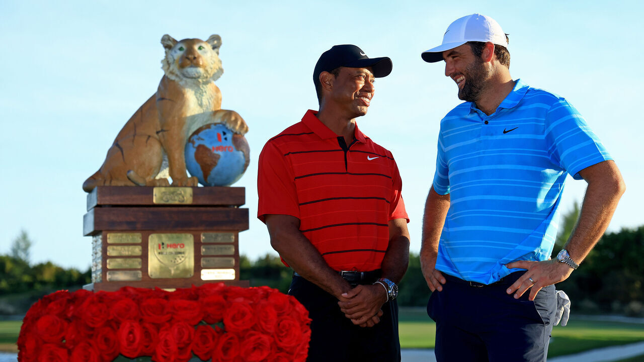 NASSAU, BAHAMAS - DECEMBER 03: Scottie Scheffler of the United States and tournament host Tiger Woods pose with the trophy after winning the final round of the Hero World Challenge at Albany Golf Course on December 03, 2023 in Nassau, .