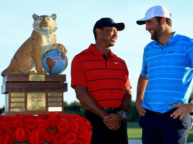 NASSAU, BAHAMAS - DECEMBER 03: Scottie Scheffler of the United States and tournament host Tiger Woods pose with the trophy after winning the final round of the Hero World Challenge at Albany Golf Course on December 03, 2023 in Nassau, .