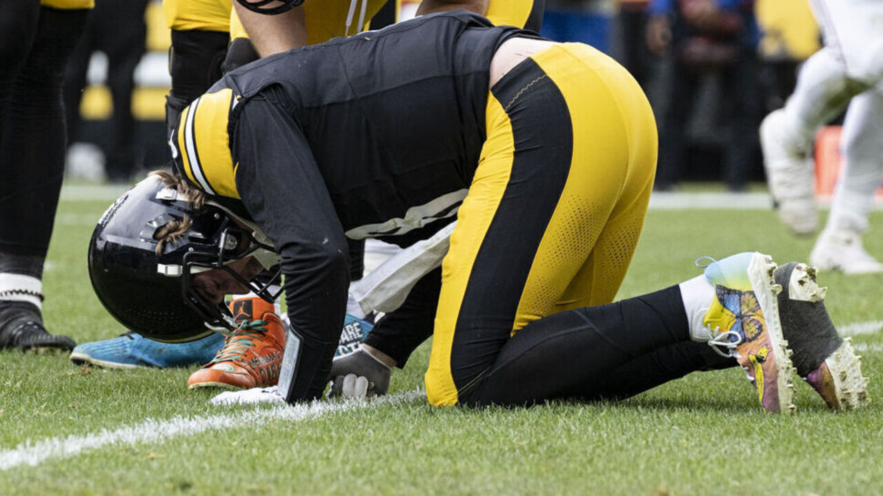 PITTSBURGH, PA - DECEMBER 03: Pittsburgh Steelers quarterback Kenny Pickett (8) doubles over in pain after being tackled by Arizona Cardinals defensive end Jonathan Ledbetter (93) and linebacker Josh Woods (10) in the first half during the game between the Pittsburgh Steelers and the Arizona Cardinals at Acrisure Stadium in Pittsburgh, PA on December 3, 2023.