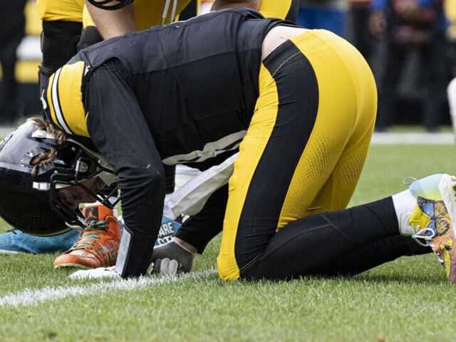 PITTSBURGH, PA - DECEMBER 03: Pittsburgh Steelers quarterback Kenny Pickett (8) doubles over in pain after being tackled by Arizona Cardinals defensive end Jonathan Ledbetter (93) and linebacker Josh Woods (10) in the first half during the game between the Pittsburgh Steelers and the Arizona Cardinals at Acrisure Stadium in Pittsburgh, PA on December 3, 2023.