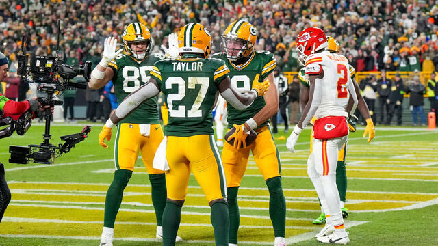 GREEN BAY, WI - DECEMBER 3: Wide receiver Christian Watson #9, tight end Tucker Kraft #85 and running back Patrick Taylor #27 of the Green Bay Packers celebrate a touch down during an NFL football game against the Kansas City Chiefs at Lambeau Field on December 3, 2023 in Green Bay, Wisconsin.