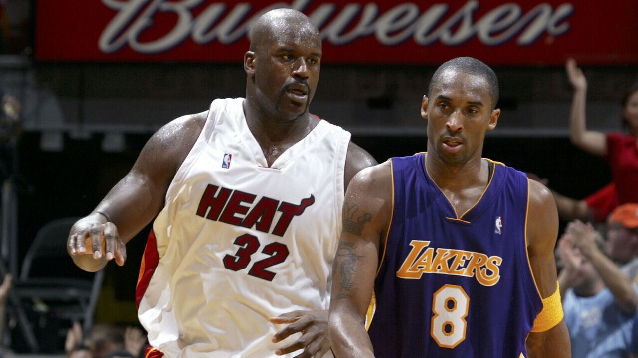 MIAMI - DECEMBER 25: Shaquille O'Neal #32 of the Miami Heat after dunking with Kobe Bryant #8 of the Los Angeles Lakers shares a word on December 25, 2005 at American Airlines Arena in Miami, Florida. The Heat defeated the Lakers 97-92. NOTE TO USER: User expressly acknowledges and agrees that, by downloading and/or using this Photograph, User is consenting to the terms and conditions of the Getty Images License Agreement. Mandatory copyright notice: Copyright NBAE 2005
