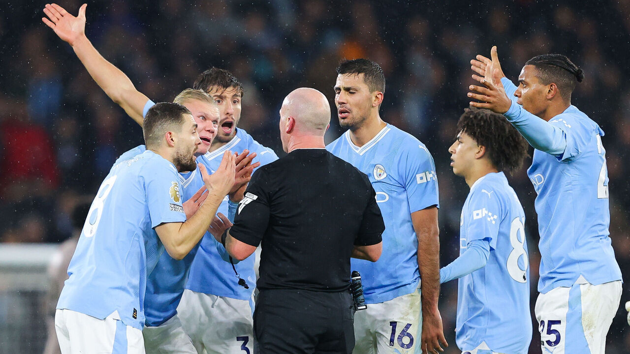 MANCHESTER, ENGLAND - DECEMBER 03: Referee Simon Hooper is surrounded by Erling Haaland, Rodri, Rico Lewis, Mateo Kovacic and Ruben Dias of Manchester City after he stopped the game to award Manchester City a free kick and deny Jack Grealish (not pictured) the chance to play on and have a goal scoring chance during the Premier League match between Manchester City and Tottenham Hotspur at Etihad Stadium on December 03, 2023 in Manchester, England.