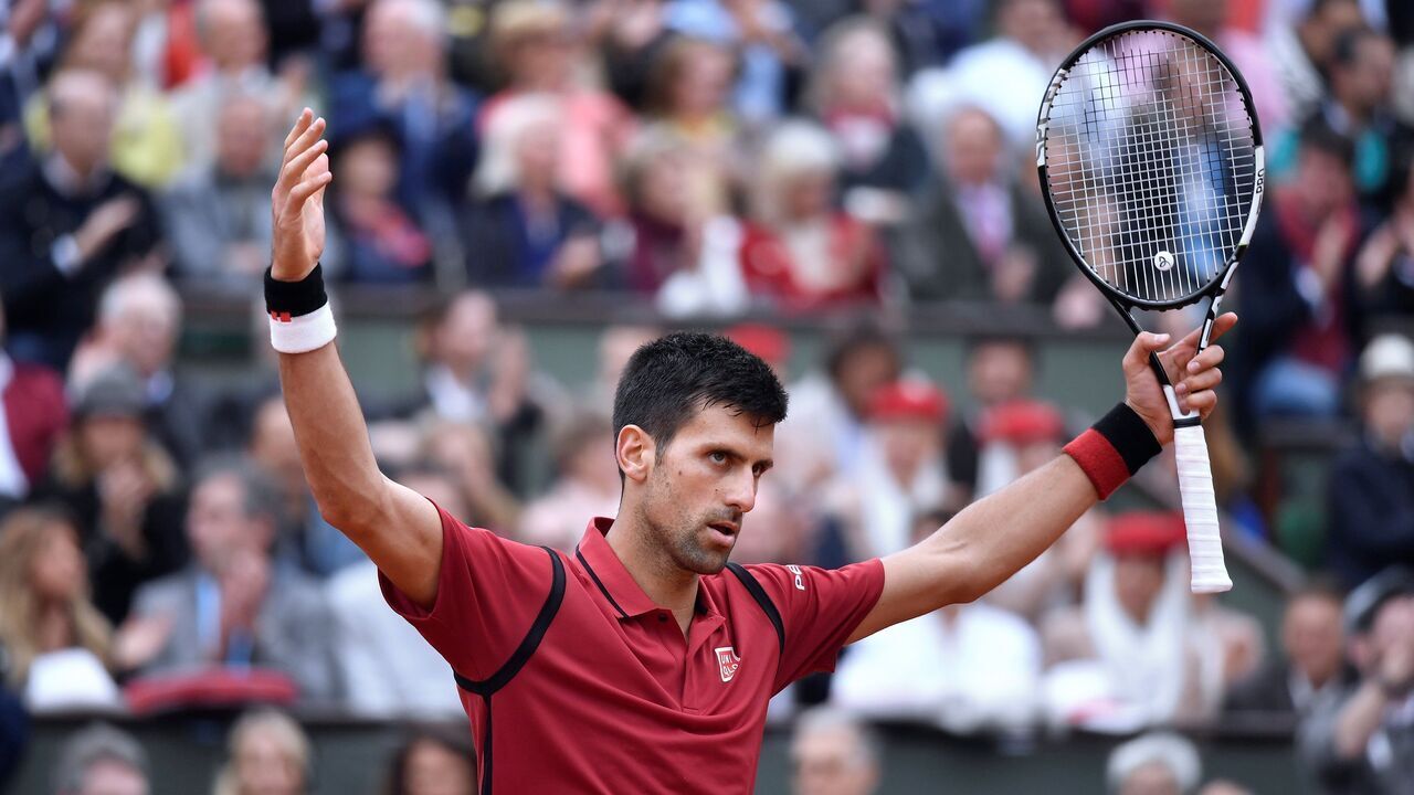 Serbia's Novak Djokovic celebrates after winning a point during the men's final match against Britain's Andy Murray at the Roland Garros 2016 French Tennis Open in Paris on June 5, 2016. / AFP / PHILIPPE LOPEZ