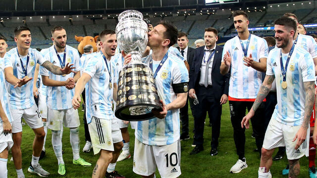 RIO DE JANEIRO, BRAZIL - JULY 10: Lionel Messi of Argentina lift and kiss the Conmebol Copa America Trophy after winning the Final of Copa America Brazil 2021 ,during the Final Match between Brazil and Argentina at Maracana Stadium on July 10, 2021 in Rio de Janeiro, Brazil.