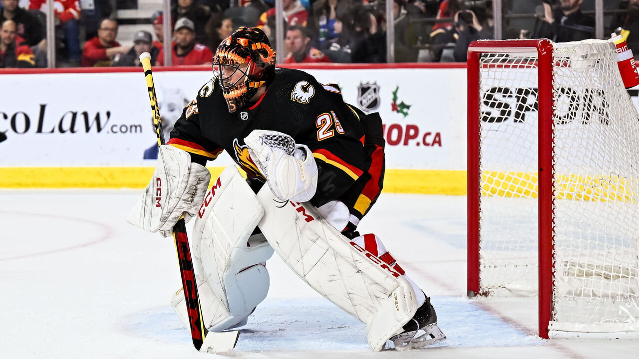 CALGARY, AB - DECEMBER 02: Calgary Flames Goalie Jacob Markstrom (25) covers his net during the second period of an NHL game between the Calgary Flames and the Vancouver Canucks on December 2, 2023, at the Scotiabank Saddledome in Calgary, AB.
