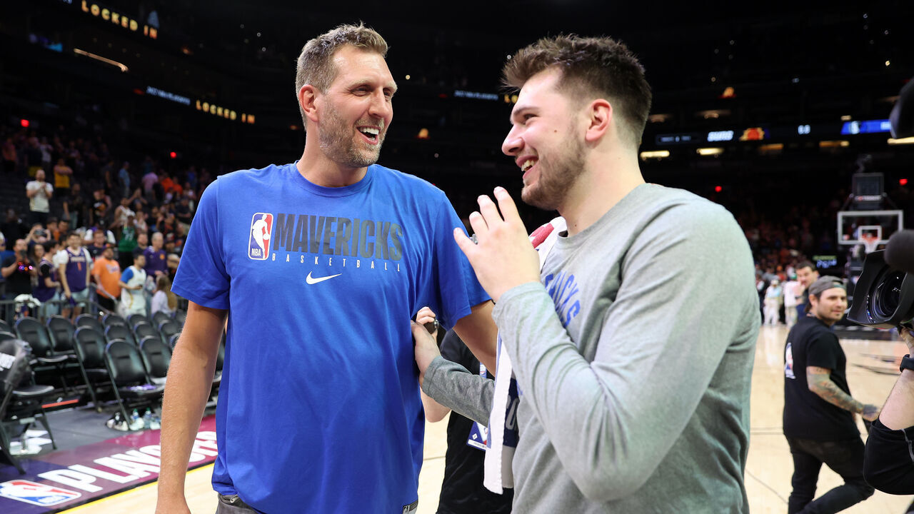 PHOENIX, ARIZONA - MAY 15: Former Dallas Mavericks player Dirk Nowitzki talks with Luka Doncic #77 of the Dallas Mavericks after the Mavericks defeated the Suns 123-90 in Game Seven of the 2022 NBA Playoffs Western Conference Semifinals at Footprint Center on May 15, 2022 in Phoenix, Arizona. NOTE TO USER: User expressly acknowledges and agrees that, by downloading and/or using this photograph, User is consenting to the terms and conditions of the Getty Images License Agreement.
