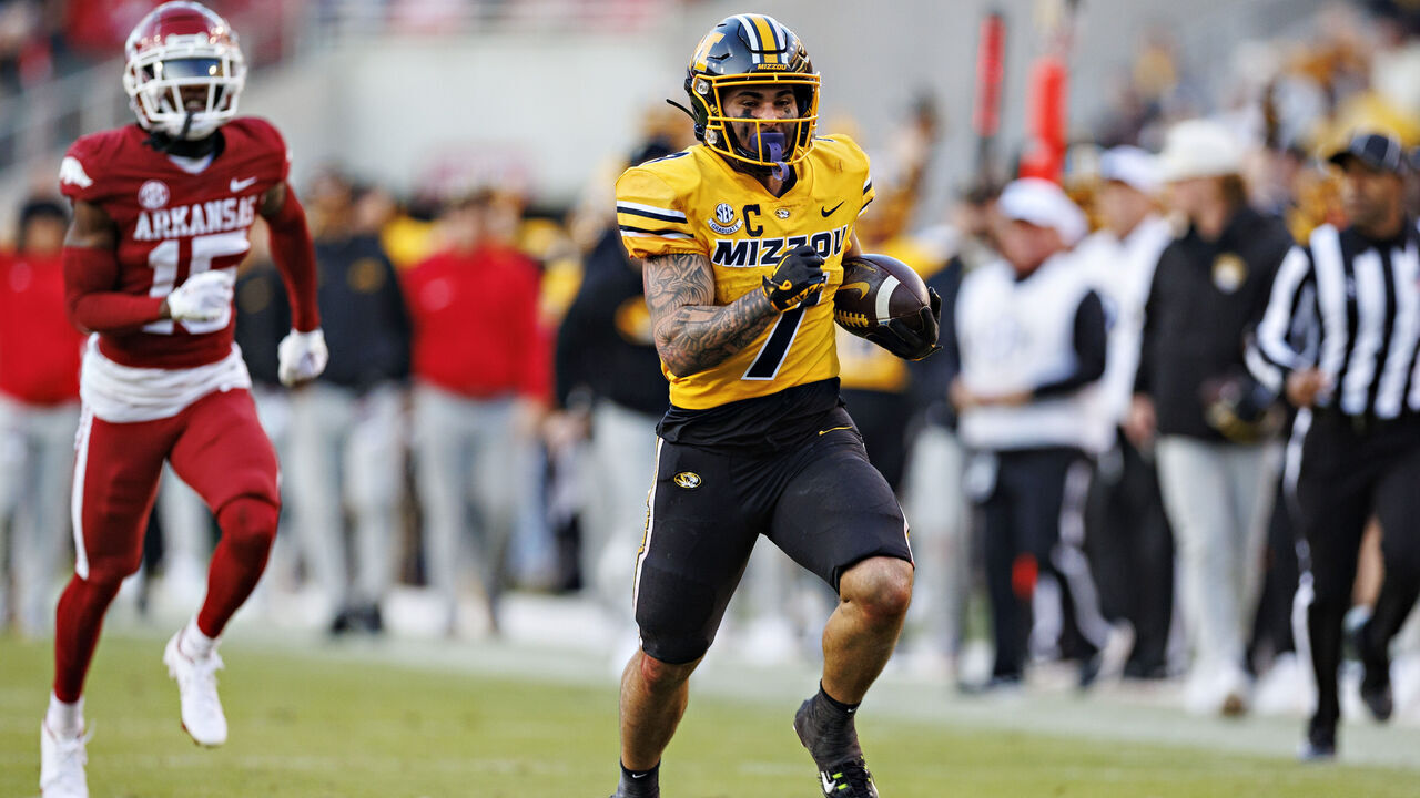 FAYETTEVILLE, ARKANSAS - NOVEMBER 24: Cody Schrader #7 of the Missouri Tigers runs the ball during the game against the Arkansas Razorbacks at Donald W. Reynolds Razorback Stadium on November 24, 2023 in Fayetteville, Arkansas. The Tigers defeated the Razorbacks 48-14.