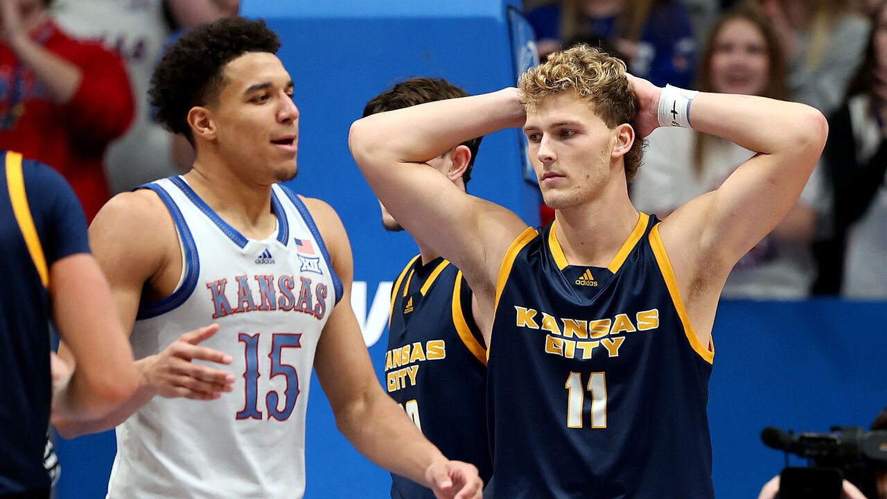 LAWRENCE, KANSAS - DECEMBER 05: Anderson Kopp #11 of the UMKC Kangaroos reacts after a foul on Kevin McCullar Jr. #15 of the Kansas Jayhawks during the 2nd half of the game at Allen Fieldhouse on December 05, 2023 in Lawrence, Kansas.