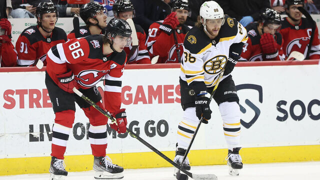 NEWARK, NJ - DECEMBER 28: New Jersey Devils center Jack Hughes (86) and Boston Bruins right wing David Pastrnak (88) await a face-off during the National Hockey League game between the Boston Bruins and the New Jersey Devils on December 28, 2022 at Prudential Center in Newark, NJ.