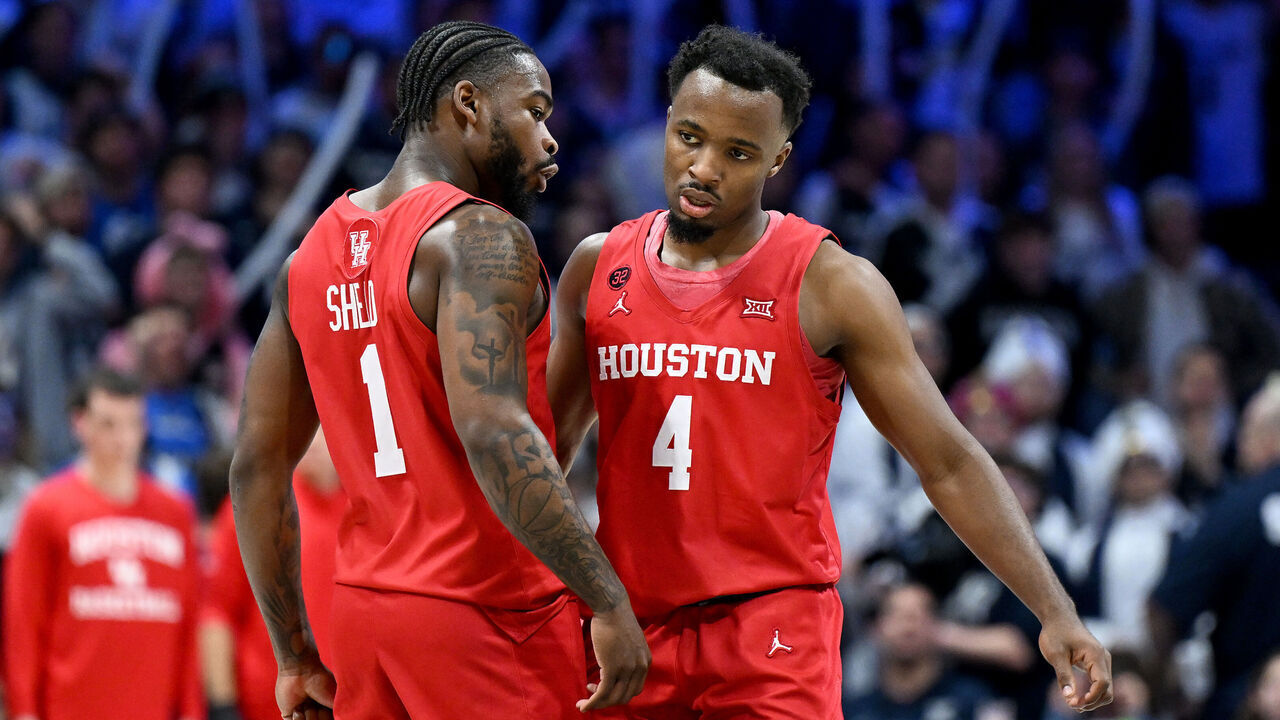CINCINNATI, OHIO - DECEMBER 01: LJ Cryer #4 of the Houston Cougars celebrates with Jamal Shead #1 during the game against the Xavier Musketeers at Cintas Center on December 01, 2023 in Cincinnati, Ohio.