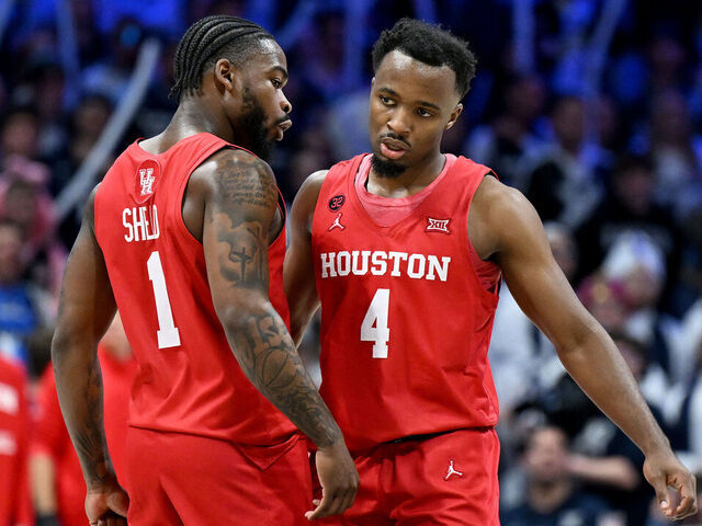 CINCINNATI, OHIO - DECEMBER 01: LJ Cryer #4 of the Houston Cougars celebrates with Jamal Shead #1 during the game against the Xavier Musketeers at Cintas Center on December 01, 2023 in Cincinnati, Ohio.