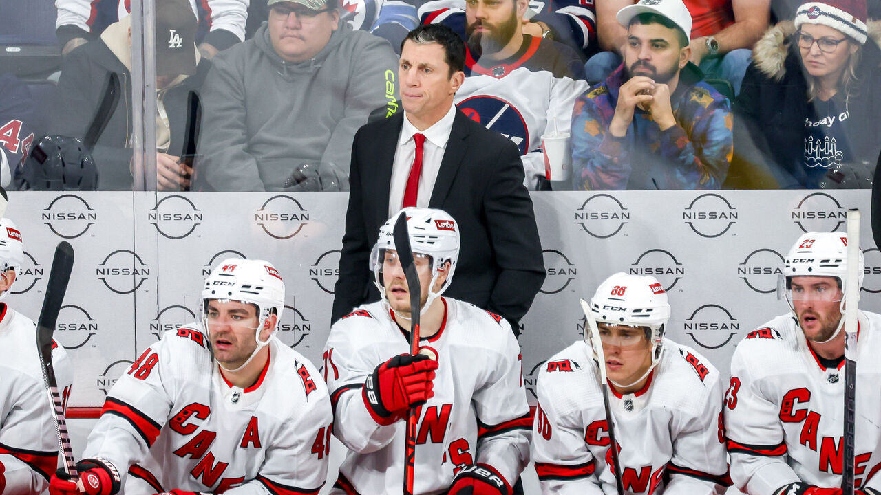 WINNIPEG, CANADA - DECEMBER 4: Head Coach Rod Brind'Amour of the Carolina Hurricanes looks on from the bench during third period action against the Winnipeg Jets at the Canada Life Centre on December 4, 2023 in Winnipeg, Manitoba, Canada.