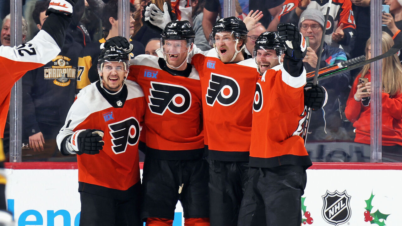 PHILADELPHIA, PENNSYLVANIA - DECEMBER 04: Sean Couturier #14 of the Philadelphia Flyers celebrates his game-winning goal in overtime against the Pittsburgh Penguins with Travis Konecny #11, Travis Sanheim #6, and Scott Laughton #21 at the Wells Fargo Center on December 4, 2023 in Philadelphia, Pennsylvania. The Flyers went on to defeat the Penguins in overtime 2-1.
