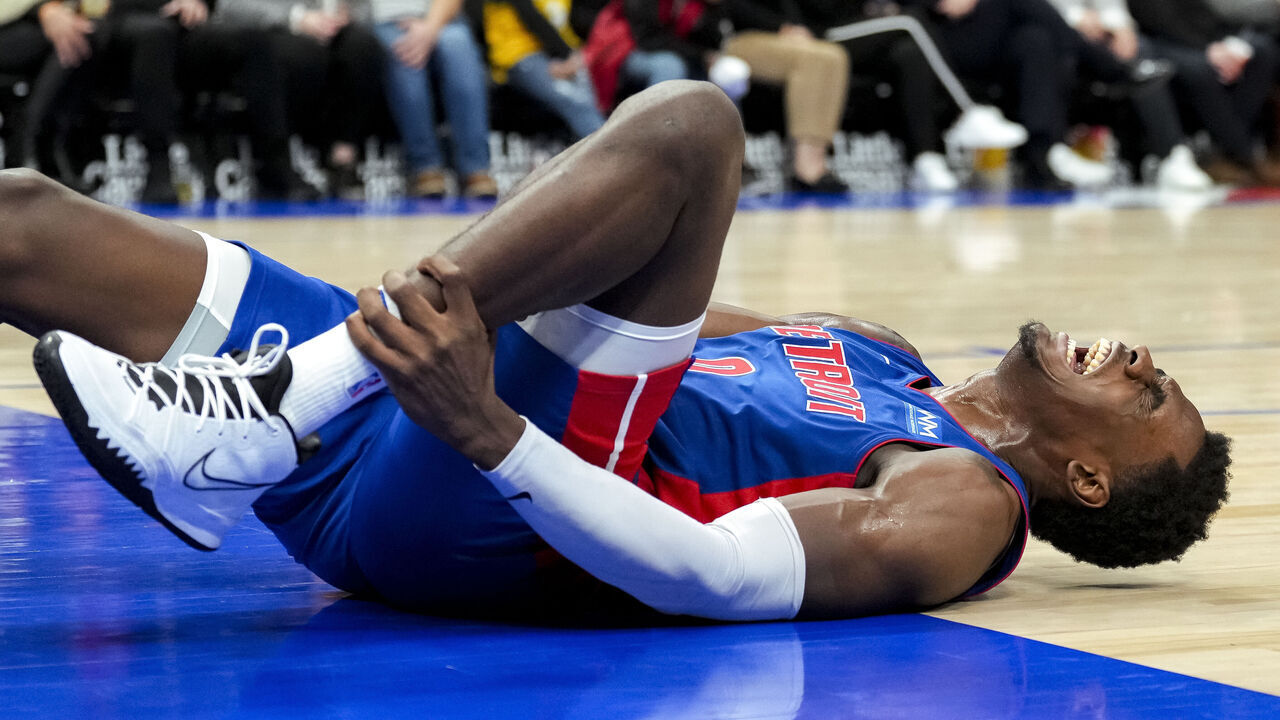 DETROIT, MICHIGAN - DECEMBER 06: Jalen Duren #0 of the Detroit Pistons reacts in pain against the Memphis Grizzlies during the fourth quarter at Little Caesars Arena on December 06, 2023 in Detroit, Michigan.