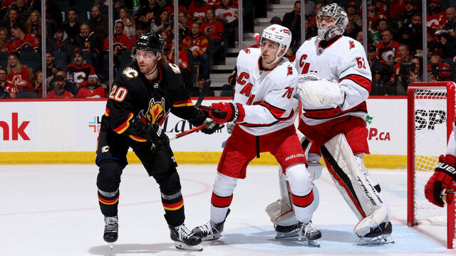 CALGARY, AB - NOVEMBER 7: Blake Coleman #20 of the Calgary Flames skates against Brady Skjei #76, Pyotr Kochetkov #52 of the Carolina Hurricanes at Scotiabank Saddledome on December 7, 2023 in Calgary, Alberta, Canada.