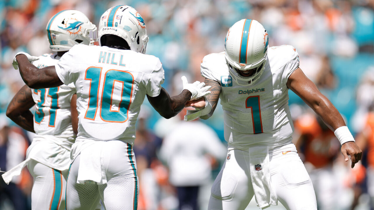 MIAMI GARDENS, FLORIDA - SEPTEMBER 24: Tua Tagovailoa #1 of the Miami Dolphins and Tyreek Hill #10 of the Miami Dolphins i action against the Denver Broncos at Hard Rock Stadium on September 24, 2023 in Miami Gardens, Florida.