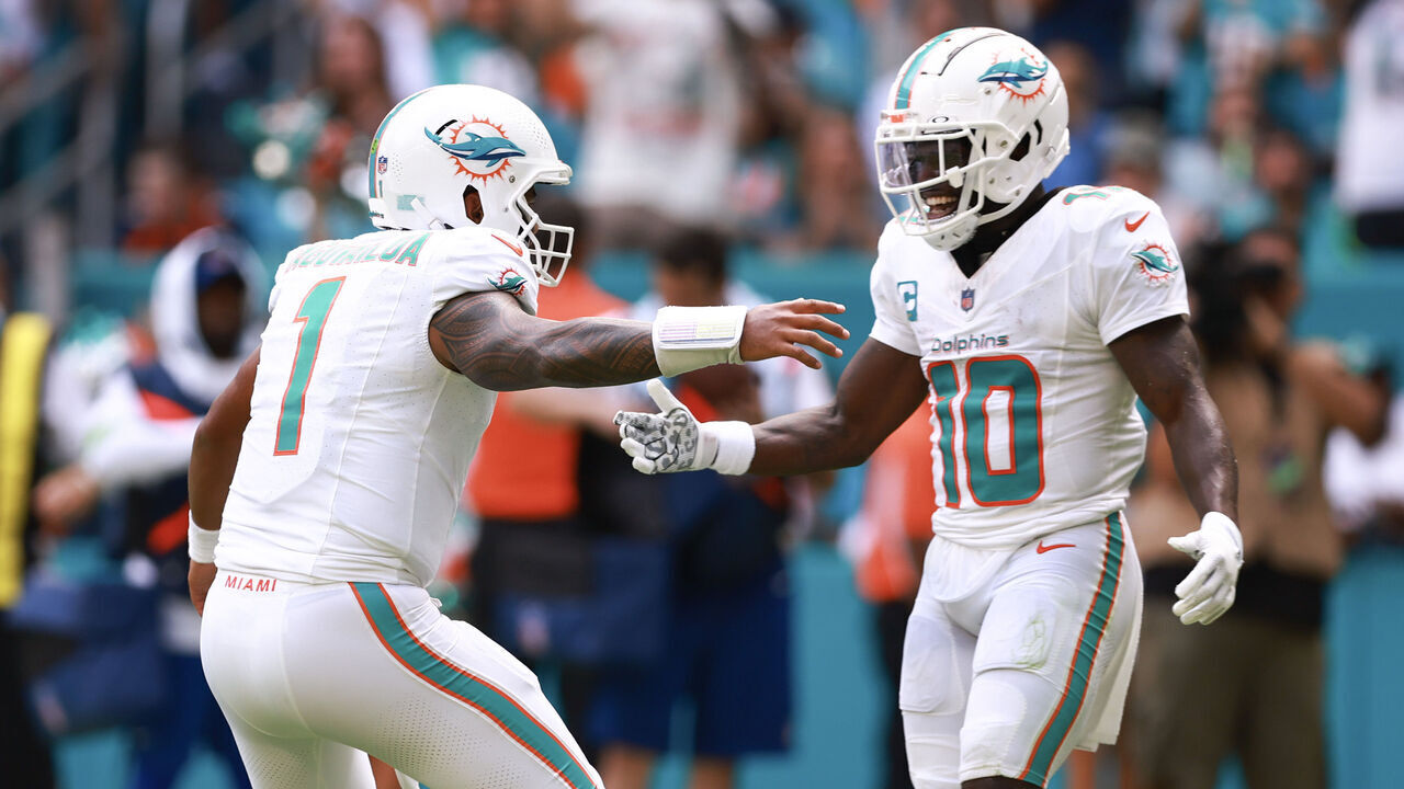 MIAMI GARDENS, FLORIDA - SEPTEMBER 24: Tua Tagovailoa #1 of the Miami Dolphins and Tyreek Hill #10 of the Miami Dolphins celebrate after a Miami touchdown during the third quarter against the Denver Broncos at Hard Rock Stadium on September 24, 2023 in Miami Gardens, Florida.