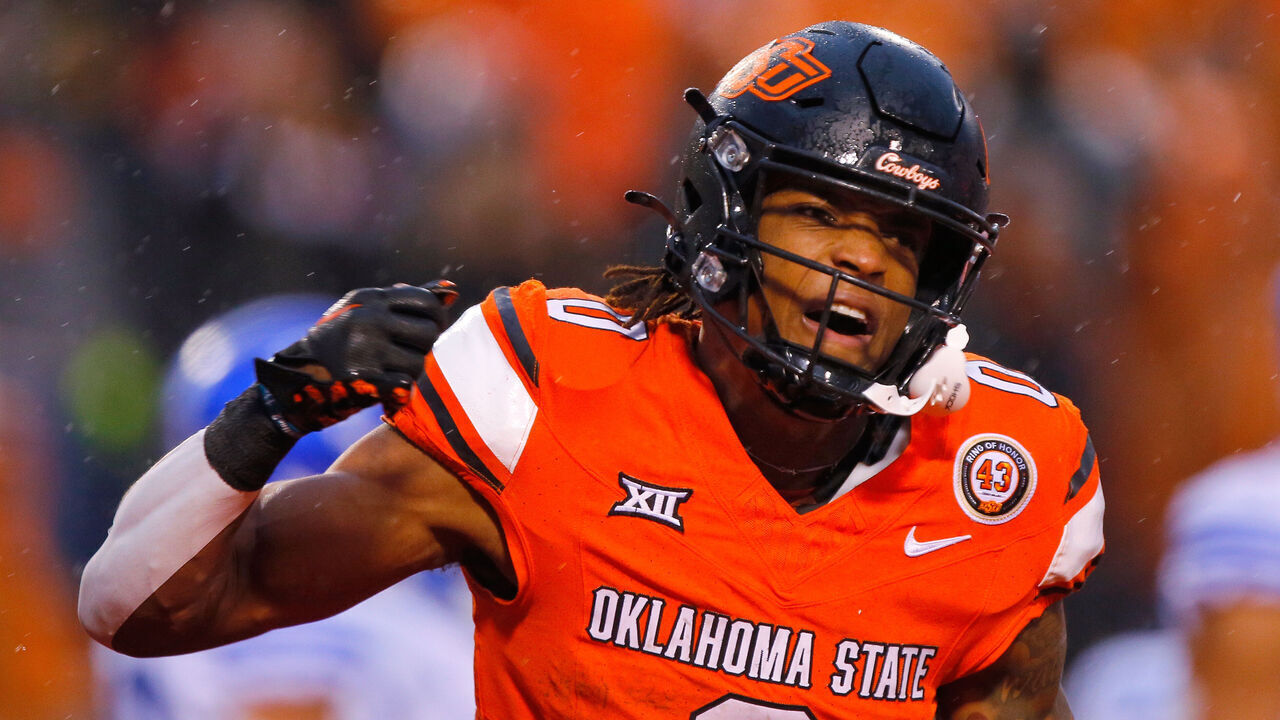STILLWATER, OK - NOVEMBER 25: Running back Ollie Gordon II #0 of the Oklahoma State Cowboys celebrates a two-yard touchdown against the BYU Cougars in the third quarter at Boone Pickens Stadium on November 25, 2023 in Stillwater, Oklahoma. Oklahoma State won 40-34 in double overtime.